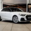 Audi A1 Sportback 30 TFSI Advanced S Tronic in a sleek urban setting, showcasing its modern design and features.