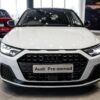 Audi A1 Sportback 30 TFSI Advanced S Tronic in a sleek urban setting, showcasing its modern design and features.